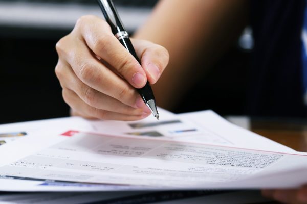 working-woman-holding-black-pen-for-signing-docume-2024-12-07-12-44-17-utc